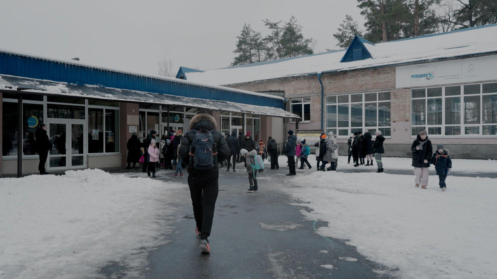 Students returning to a recently reopened school in Ukraine